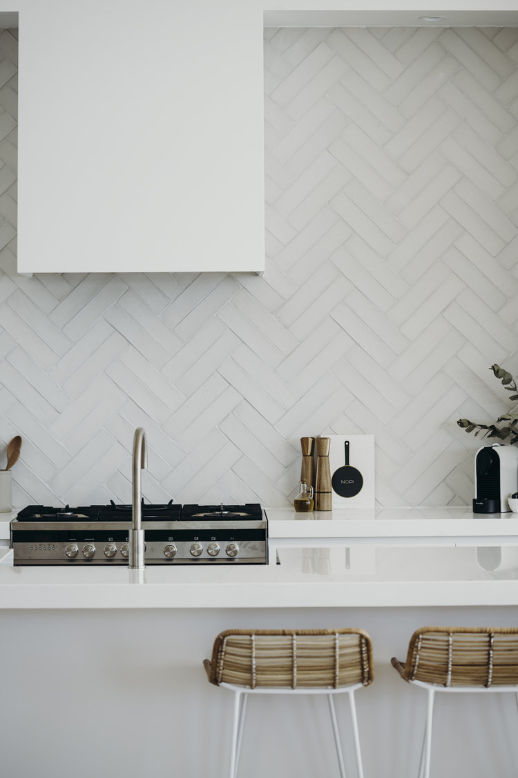 white kitchen with chevron backsplash tile option