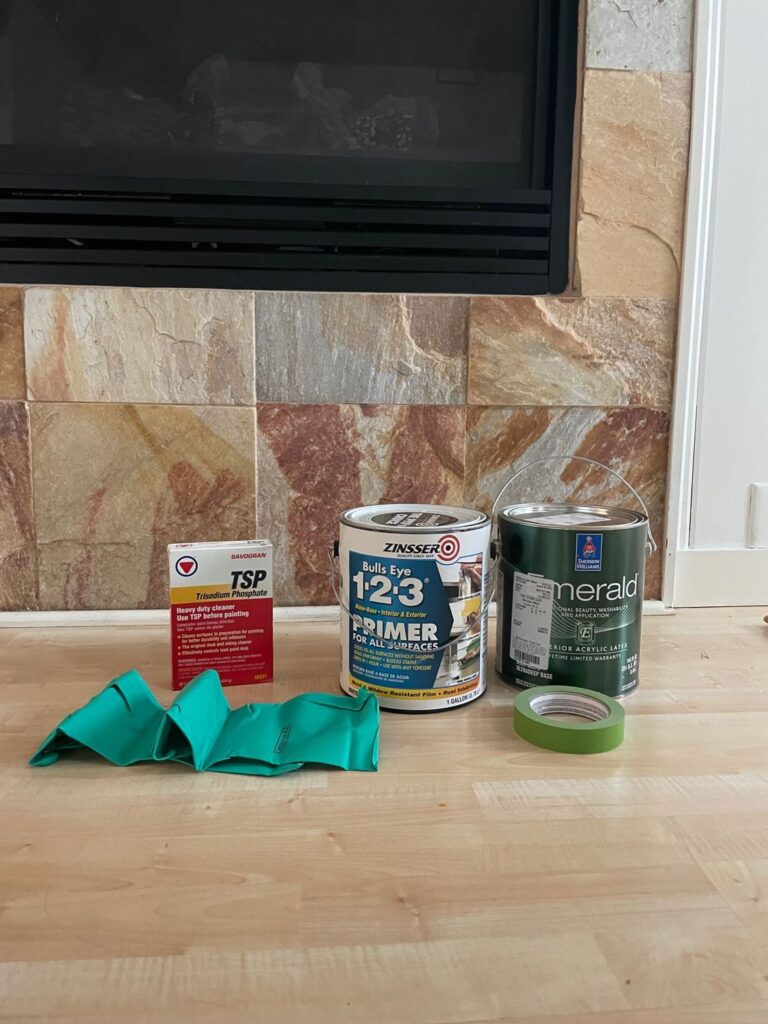 paint supplies in front of a stone fireplace