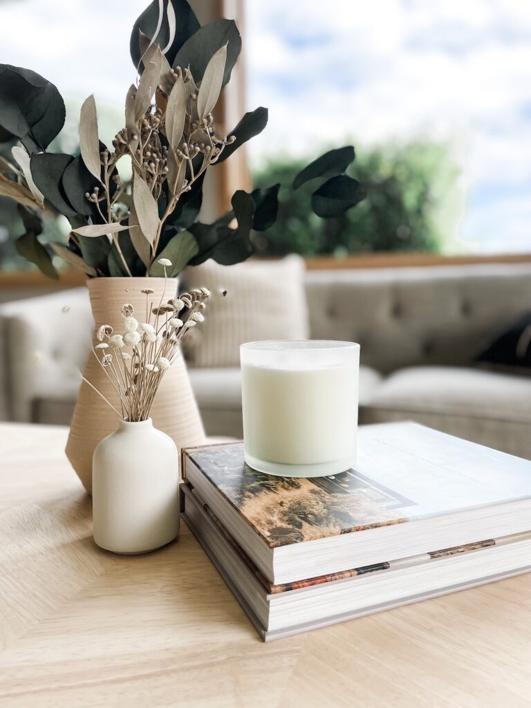 coffee table home decor with vases, candles, and dried greenery