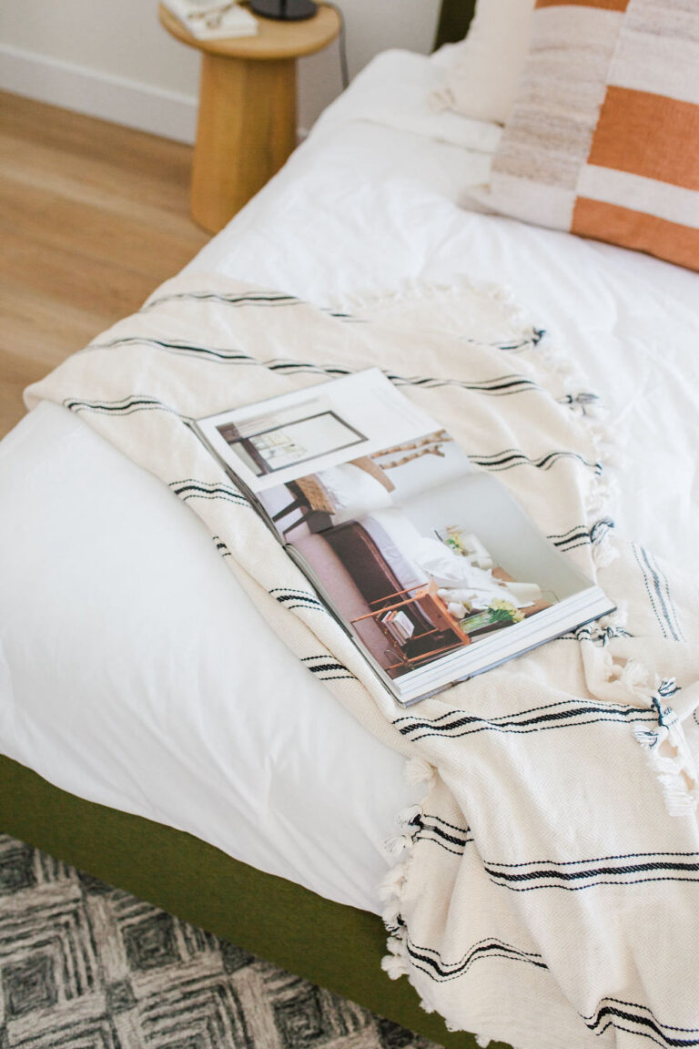 bed with home decor pages laying on top of it