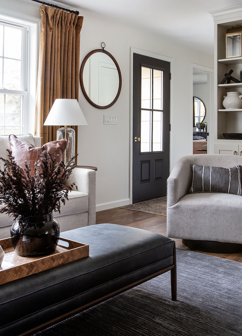 transitional living room with coffee table, chair, and curtains