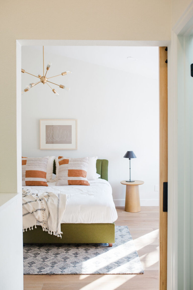 bedroom with pillows, blankets, and light