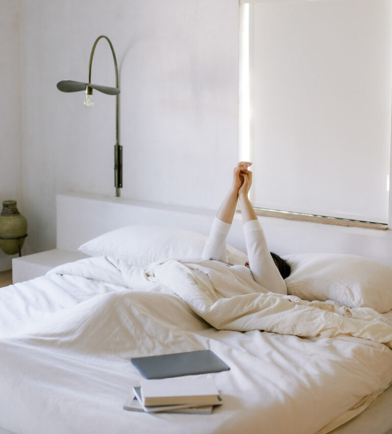 woman in bed with books