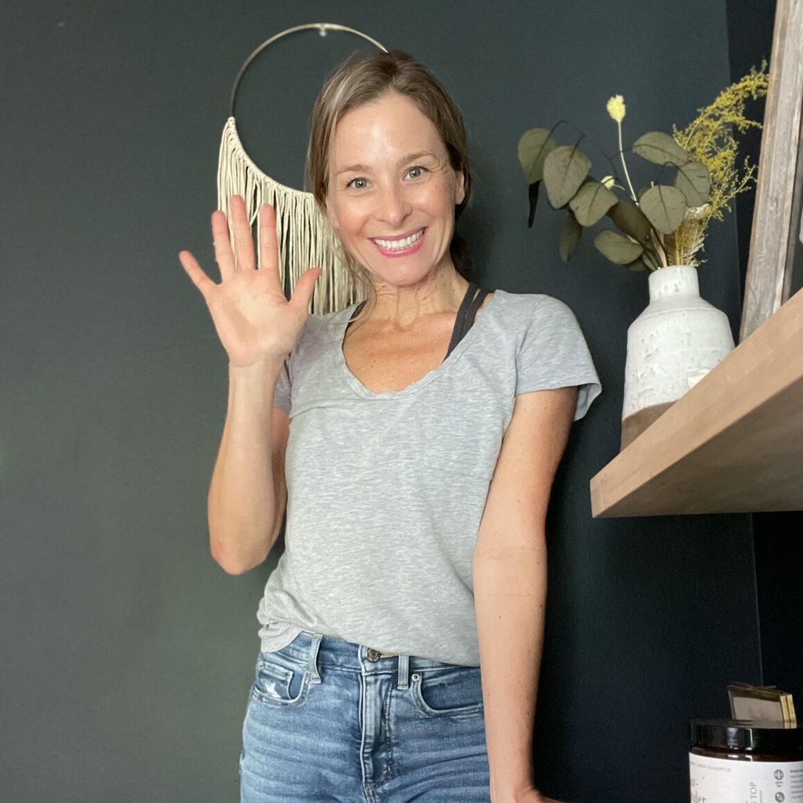photo of allisa jacobs, woman, in front of black wall with decor