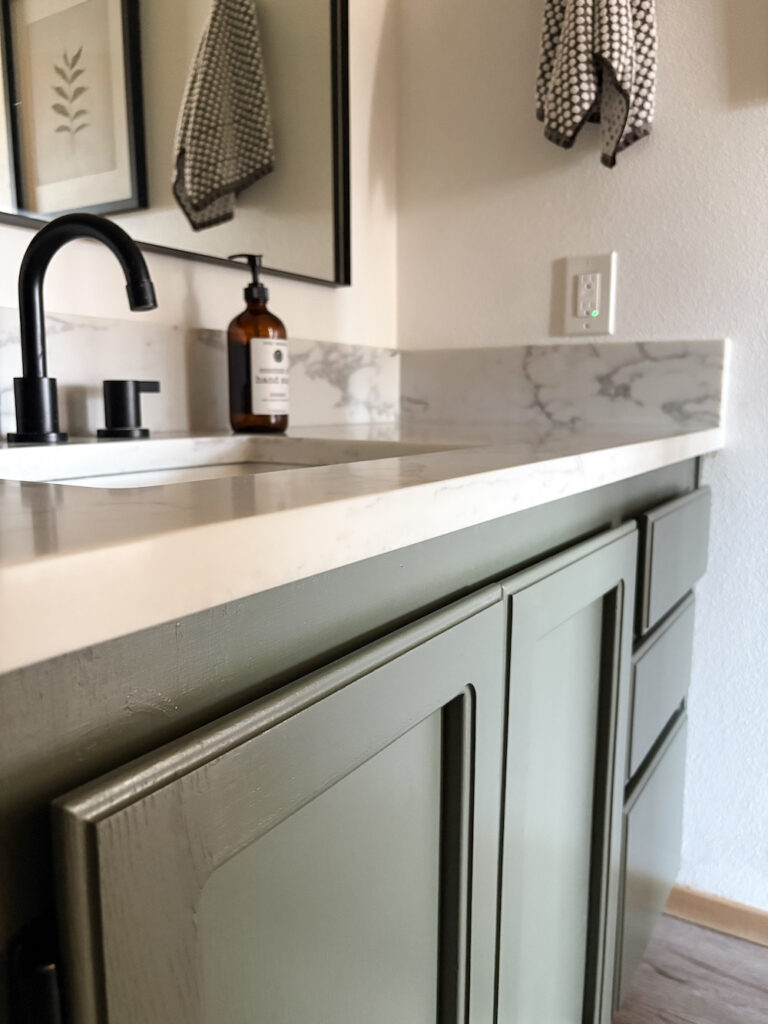 bathroom with green painted vanity